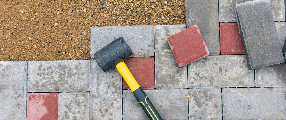 Pavers with a hammer set ontop of them in Bonita Springs, FL.